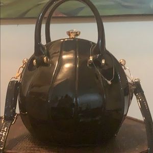 Black basketball shaped purse with cheetah inside